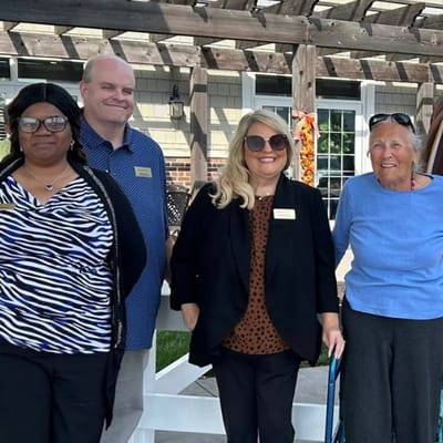 Staff and resident posing outdoors