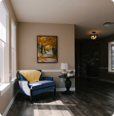 Cozy interior space with a blue chair and artwork