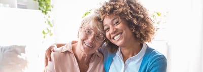 Two residents smiling together in a bright room