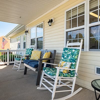 Outdoor seating area with rocking chairs and cushions