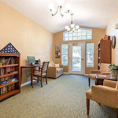 Cozy common area with seating and bookshelf
