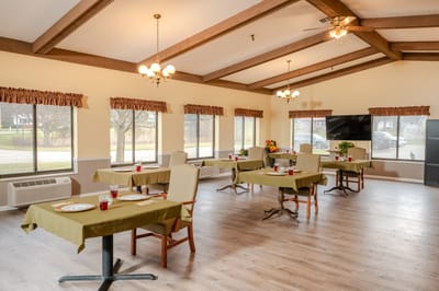 Bright dining room with tables set for residents