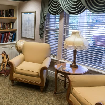 Cozy lounge area with chairs and a lamp