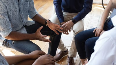 Group of people engaged in conversation indoors