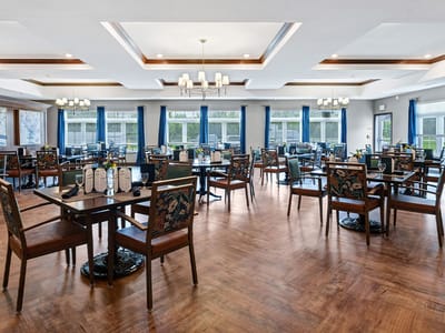 Dining area with tables and chairs set for meals