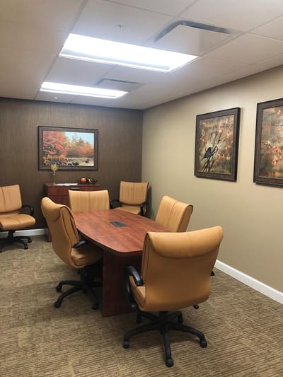 A meeting room with chairs and a table