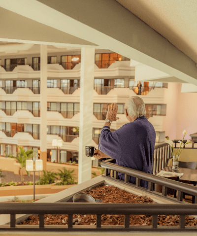Resident enjoying a view from the balcony
