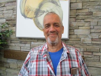 A resident smiling in a well-lit common area