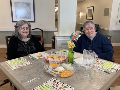 Two residents enjoying a meal at a table