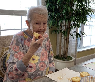 Resident enjoying a snack in a facility common area