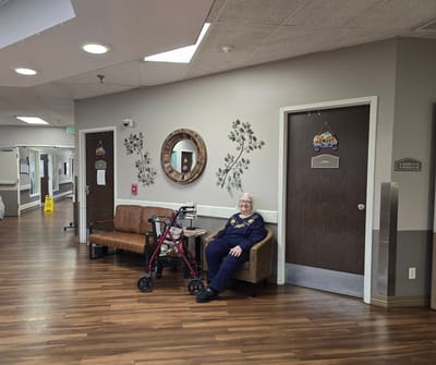 A resident sitting in a cozy common area.