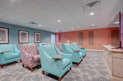 Quiet common area with colorful seating in a senior living facility