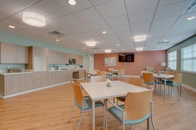 Bright and inviting common area with tables and chairs