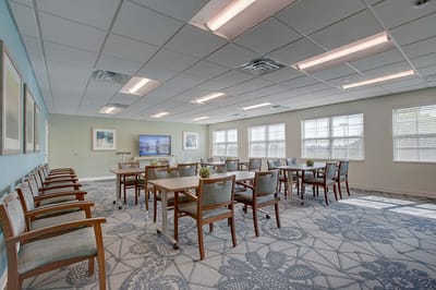 A bright common area with tables and chairs