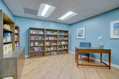 Brightly lit interior room with shelves of supplies