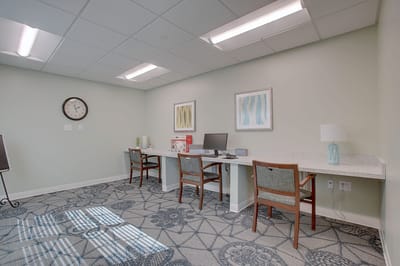 A cozy interior room with desks and computer stations