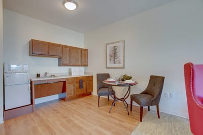 Updated interior of a resident's room with dining setup