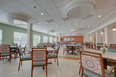 Dining area with tables and chairs in a bright setting