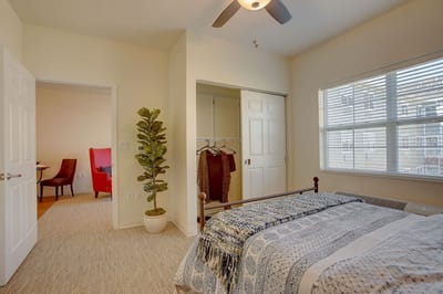 A cozy resident room with a bed and seating area