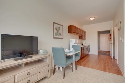 Cozy resident room with kitchenette and TV