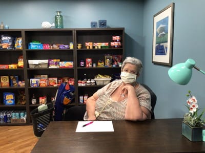 Resident sitting in a common area with snacks visible