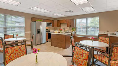 Bright dining area with tables and kitchen appliances