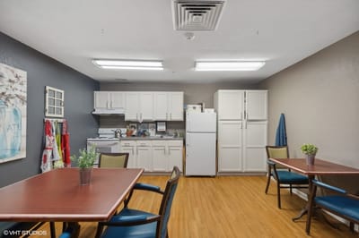 Bright kitchen area with tables and seating