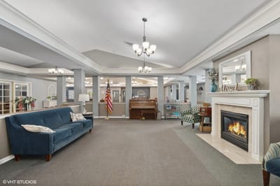 Bright common area with seating and a fireplace