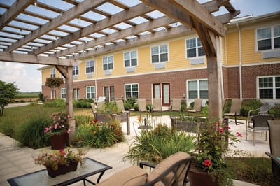 Outdoor patio area with seating and flowers