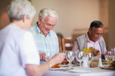 Residents enjoying a meal together in the dining room