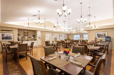 Brightly lit dining room with tables and chairs