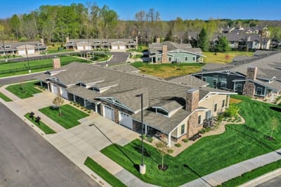 Aerial view of a senior living campus with buildings and green spaces