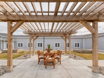 Outdoor seating area under a wooden trellis