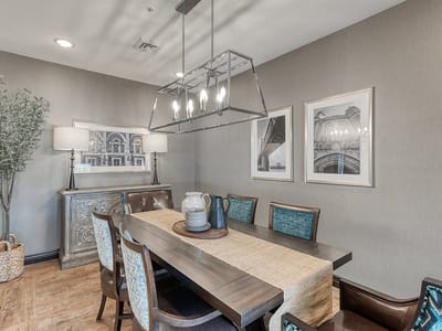 A well-decorated dining area with wooden table and chairs