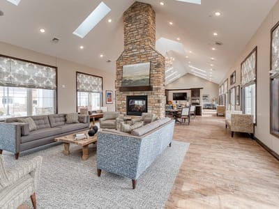 Bright common area with comfortable seating and fireplace