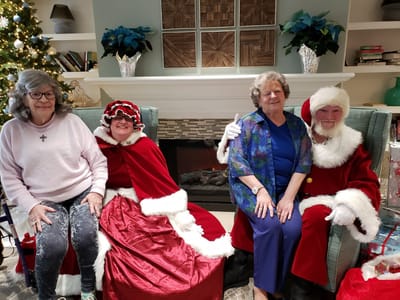 Residents enjoying a holiday celebration with Santa Claus