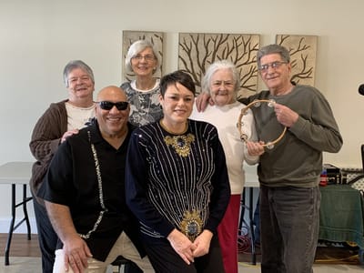 Residents and staff enjoying a music activity together