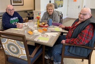 Residents enjoying a meal together at a dining table