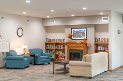 Cozy common area with seating and bookshelves