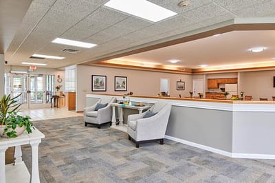 Lobby area with seating and kitchen in background