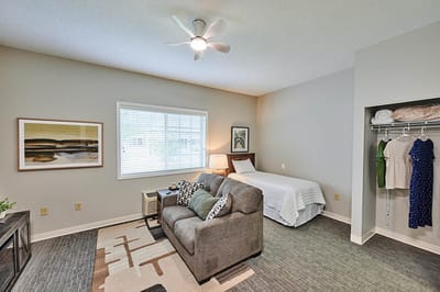 Private resident room with a couch and bed.