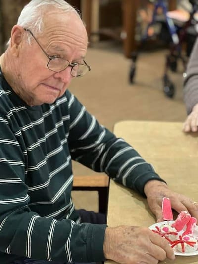 An elderly man engaged in an arts and crafts activity