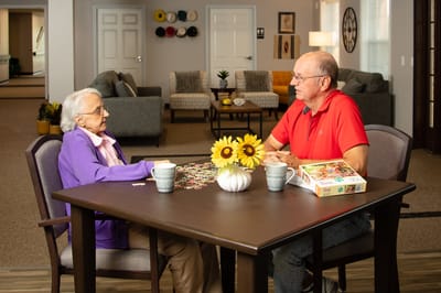 Residents engaging in a puzzle activity at a communal table