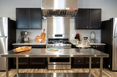 Modern kitchen with stainless steel appliances and baked goods
