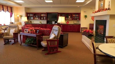 Cozy common area with comfortable seating and bookshelf