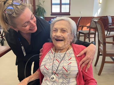 A caregiver and resident sharing a joyful moment