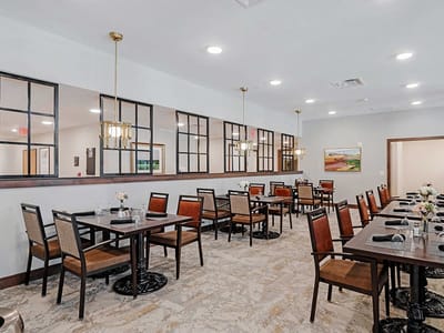 A dining room with tables and chairs set up