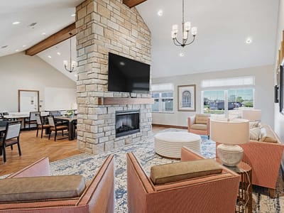 Bright common area with seating and a fireplace
