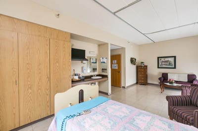 Bright and clean private resident room with furnishings