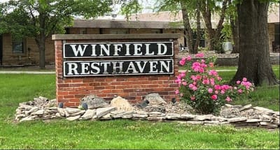 Facility sign with landscaping in front